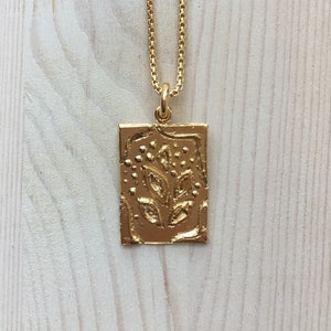 Golden amulet with abstract ornaments, rectangular pendant with organic leaf ornaments