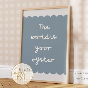 May include: A framed print with the text "The world is your oyster" in white script on a blue background with a scalloped edge. The frame is light wood. A logo is in the lower left corner, and text at the bottom right says "Frame not included."