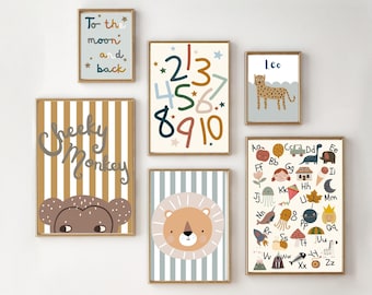 May include: A set of nine colorful prints featuring a monkey, lion, cheetah, alphabet, numbers, and a phrase about the moon. The prints are framed in gold and have a striped background.