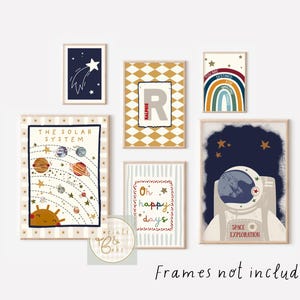May include: A collection of framed art prints with a space theme. The prints feature illustrations of a shooting star, a solar system, a rainbow, an astronaut, and the text "Oh happy days". The prints are in neutral colors with a whimsical style.