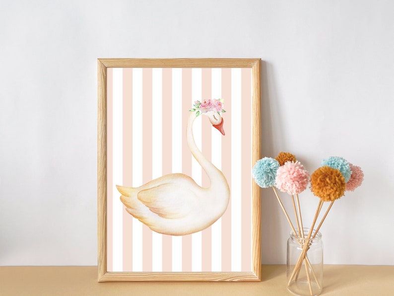 May include: A framed print of a white swan with a pink flower crown on a pink and white striped background.