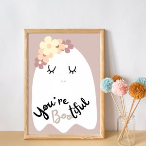 May include: A white ghost with a flower crown and closed eyes, on a light pink background. The ghost says "You're Boo-tiful".