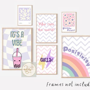 May include: A set of framed art prints in pastel colours. The prints display diverse designs, including a checkerboard pattern with a boba drink, a floral design, a rainbow, and text that reads "It's a Vibe", "Who runs the world?", "Girls!", and "Positivity".