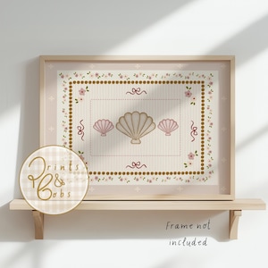 May include: A framed print featuring a seashell design. The artwork showcases a central large seashell flanked by two smaller ones, all in a beige hue, set against a striped background. The frame is light wood, and the print includes floral and ribbon accents. The text "Frame not included" is visible.