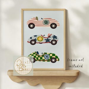 May include: Framed print of three vintage race cars: red and white striped, blue with stars, and green chequered. Each car has a different number. The text "Frame not included" is visible.
