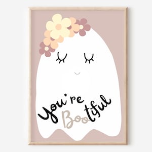 May include: A white ghost with a pink background and a flower crown. The ghost has closed eyes and a smiling mouth. The text "You're Bootiful" is written below the ghost.