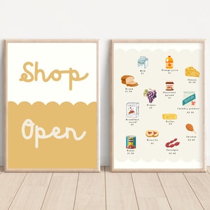May include: Two framed illustrations. The first frame has a yellow background with the text "Shop Open" in white. The second frame has a white background with a list of grocery items and prices. The items include milk, orange juice, cheese, bread, grapes, chocolate spread, laundry powder, butter, chicken, biscuits, and sausages.