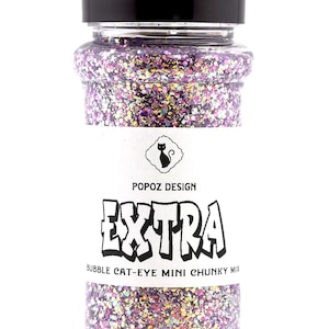 May include: A clear plastic bottle filled with iridescent glitter. The label reads "POPOZ DESIGN EXTRA BUBBLE CAT-EYE MINI CHUNKY MIX" with a cat silhouette. The bottle has a black cap.