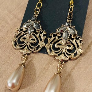 Dangle earrings with gold and gemstone accents