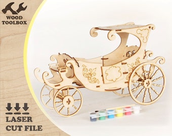 May include: Wooden model kit of a horse-drawn carriage with intricate details. The kit includes paint and a brush for assembly and decoration.  The carriage is made of wood and has a light brown colour.