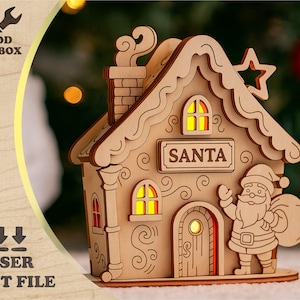 Puede incluir: Una casa de Navidad de madera cortada con láser con la palabra "SANTA" en un letrero. La casa presenta una chimenea, ventanas y una figura de Papá Noel. La imagen también incluye el texto "WOOD TOOLBOX" y "LASER CUT FILE".