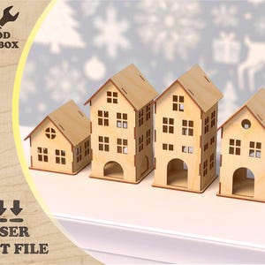 Puede incluir: Cuatro modelos de casas de madera cortadas con láser de diferentes tamaños. Las casas son de madera clara con ventanas rectangulares y puertas arqueadas. El texto "WOOD TOOLBOX" y "LASER CUT FILE" está incluido.