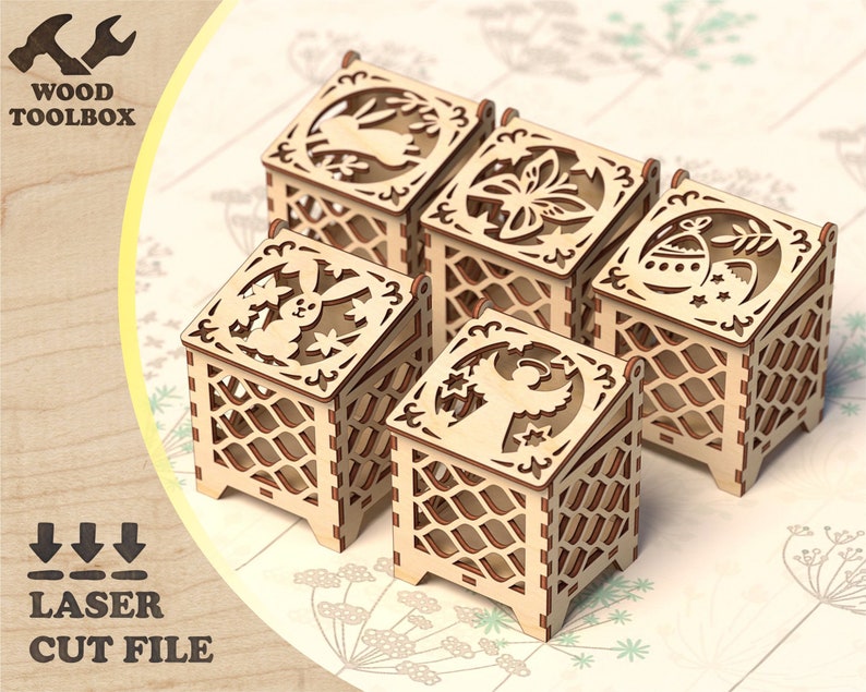 May include: Five wooden boxes with intricate laser cut designs. Each box features a different Easter theme, including a bunny, a flower, an angel, and Easter eggs. The boxes are made of light brown wood and have a delicate, intricate design.