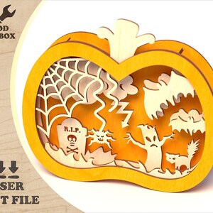May include: A laser cut wooden pumpkin with a Halloween theme. The pumpkin is orange and has a cutout design of a spider web, a bat, a ghost, a tree, a tombstone with the text "R.I.P." and a cat.