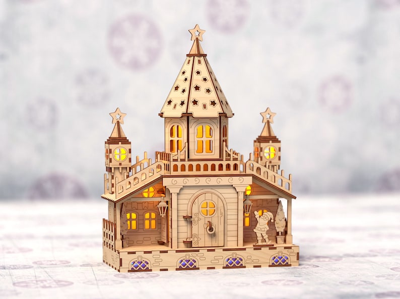 May include: A wooden Christmas village scene with a light-up castle, a Santa Claus figurine, and a Christmas tree. The castle has a pointed roof with a star on top and windows with glowing lights. The scene is made of wood and has a rustic, handcrafted look.