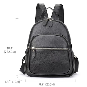 May include: Black leather backpack with silver zippers and hardware. The backpack measures 10.4 inches tall, 8.7 inches wide, and 1.3 inches deep.