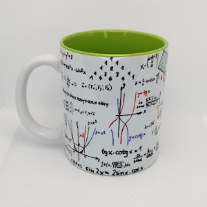 Könnte beinhalten: Eine weiße Keramiktasse mit grünem Rand. Die Tasse ist mit schwarzen Tintenzeichnungen von mathematischen Gleichungen und Graphen bedeckt. Der Text auf der Tasse lautet: "x-sin2x", "sinxcosytoosx siny", "y=tgx", "y=cotgx", "tyx.cotgx=1", "SR(x, olx sind sing", und "c sin 2x= 2sinx.cosx".
