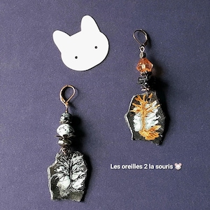 Peut inclure: Ensemble de trois mugs en céramique avec une finition mate et mouchetée. Les mugs sont de couleur crème, gris clair et gris foncé. Chaque mug a un design simple et minimaliste avec une anse arrondie.