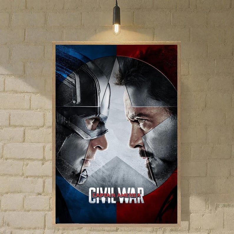 May include: A framed poster depicting Captain America and Iron Man facing each other, set against a split background of blue and red. A white star is in the centre. The words "CIVIL WAR" are displayed at the bottom of the poster.