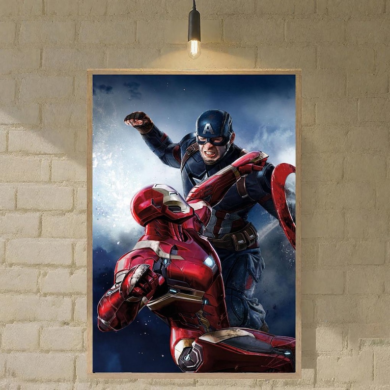 May include: A framed print depicting Iron Man and Captain America in a battle scene. Iron Man is in a red and gold suit, and Captain America is in a blue, red, and white suit, with his shield. The background is a dark blue with clouds.