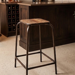 May include: A bar stool featuring a square seat constructed from three horizontal wooden planks with a natural grain finish. The frame is made of dark brown metal tubing, forming four legs connected by a square support brace near the base.