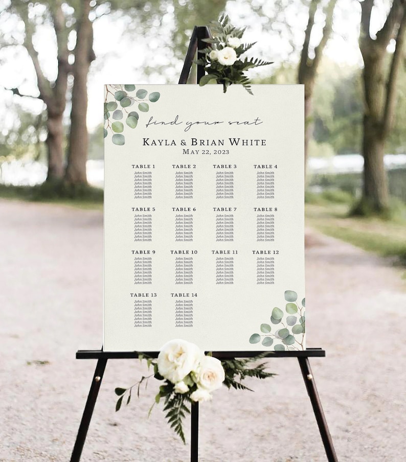 Pode incluir: Um mapa de lugares de casamento com um fundo r&uacute;stico e acentos de vegeta&ccedil;&atilde;o. O gr&aacute;fico lista as mesas de 1 a 14 com os nomes dos convidados. O texto no topo diz "find your seat Kayla & Brian White May 22, 2023".