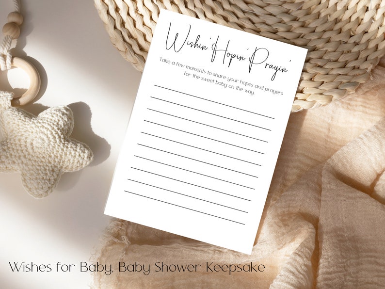 Pode incluir: Um cart&atilde;o branco com texto preto que diz "Wishin' Hopin' Prayin'" e "Take a few moments to share your hopes and prayers for the sweet baby on the way." O cart&atilde;o tem linhas para escrever. O cart&atilde;o est&aacute; sobre um fundo de tecido bege.