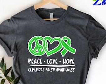 May include: A dark gray t-shirt with a green peace sign, heart, and ribbon with white outlines. The text "Peace. Love. Hope. Cerebral Palsy Awareness" is printed below the design.
