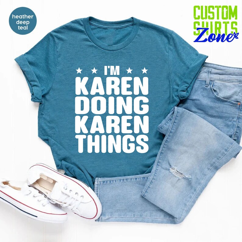 May include: A teal blue t-shirt with white text that reads "I'm Karen Doing Karen Things" with stars on either side of the word "I'm".