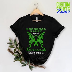May include: Black t-shirt with a green butterfly design and the text "Cerebral Palsy is not contagious (but my smile is)".