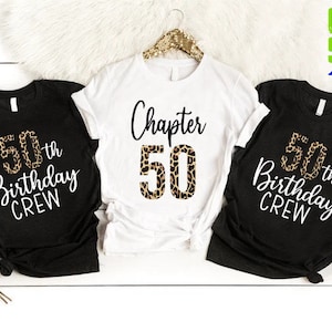 May include: Three black t-shirts with white text and a leopard print design. The shirts say "50th Birthday Crew" and "Chapter 50".
