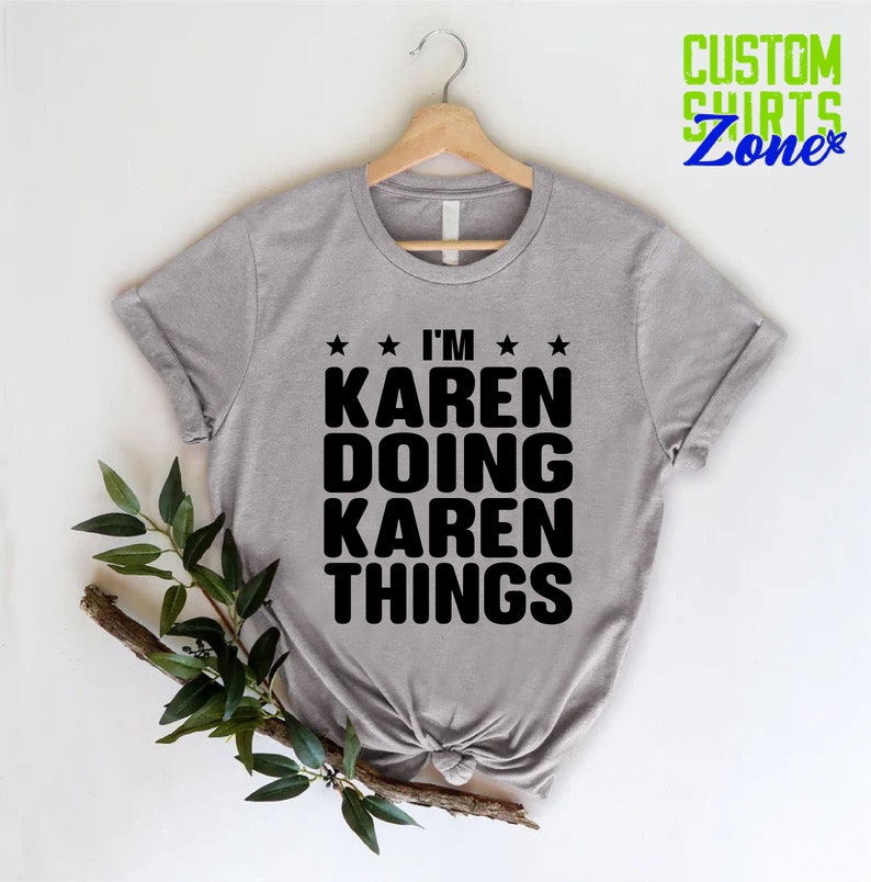 May include: A gray t-shirt with the text "I'm Karen Doing Karen Things" in black lettering. The shirt is on a hanger and has a white background.