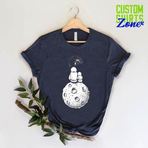a t - shirt with an image of a man on the moon