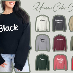 Puede incluir: Carta de colores unisex para sudaderas con capucha que muestra varios colores, incluyendo negro, blanco, gris oscuro jaspeado, arena, gris deportivo, granate, verde militar, verde bosque, rojo escarlata jaspeado y rojo.