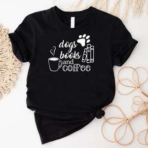 a black t - shirt with a dog's paw and coffee on it
