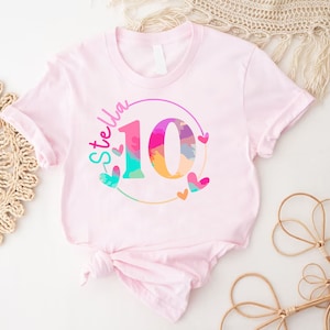 a pink shirt with the number ten printed on it