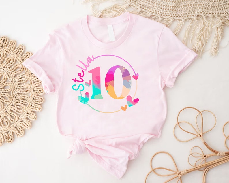 a pink shirt with the number ten printed on it