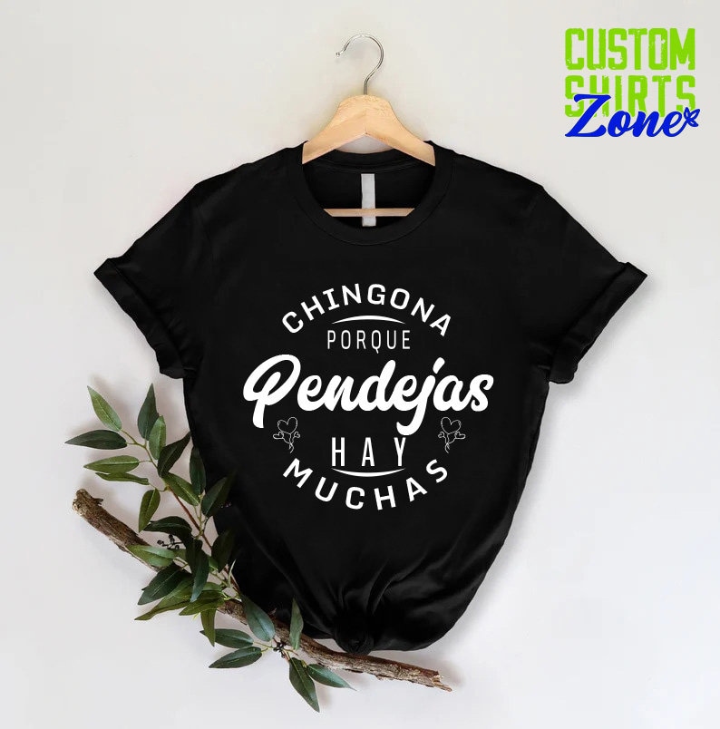 May include: Black t-shirt with white text that reads "Chingona Porque Pendejas Hay Muchas".