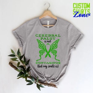 May include: Gray t-shirt with a green butterfly design and the text "Cerebral Palsy is not contagious (but my smile is)".