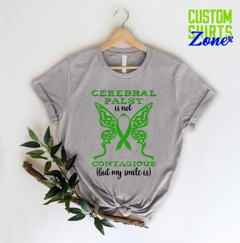 May include: Gray t-shirt with a green butterfly design and the text "Cerebral Palsy is not contagious (but my smile is)".