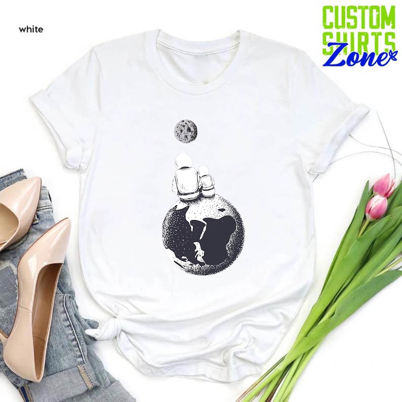 a t - shirt with a picture of a person on top of a globe