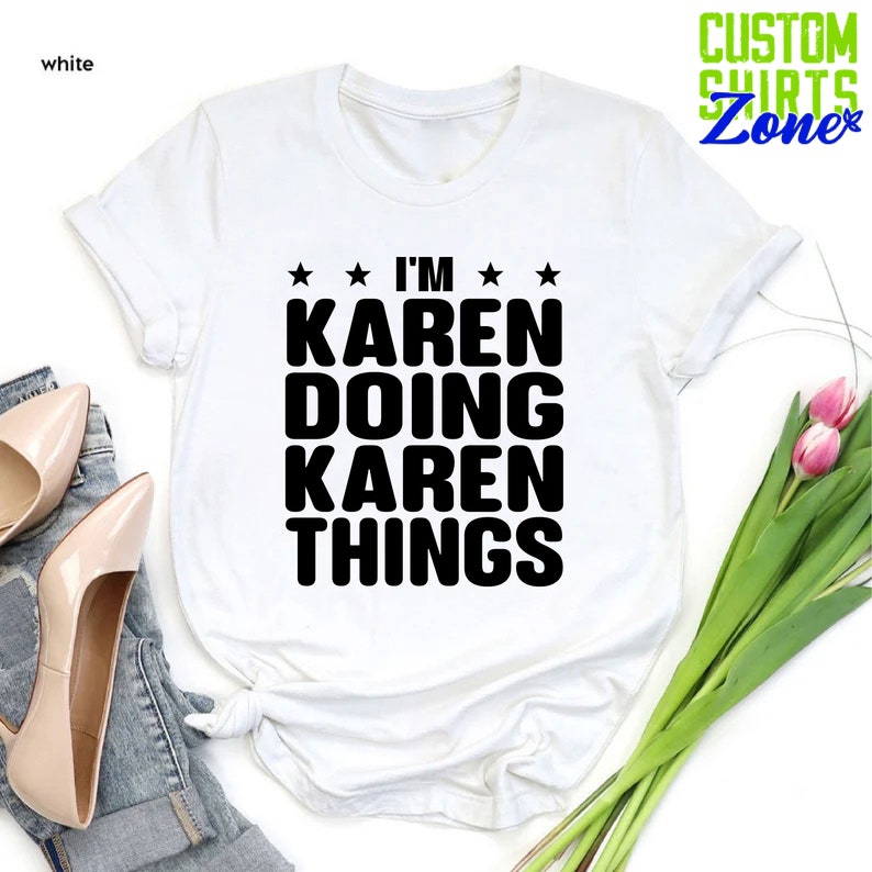 May include: White t-shirt with black text that reads "I'm Karen Doing Karen Things" with stars on either side of the text.