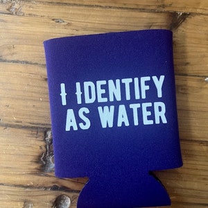 May include: Purple can cooler with the text "I identify as water" in white.