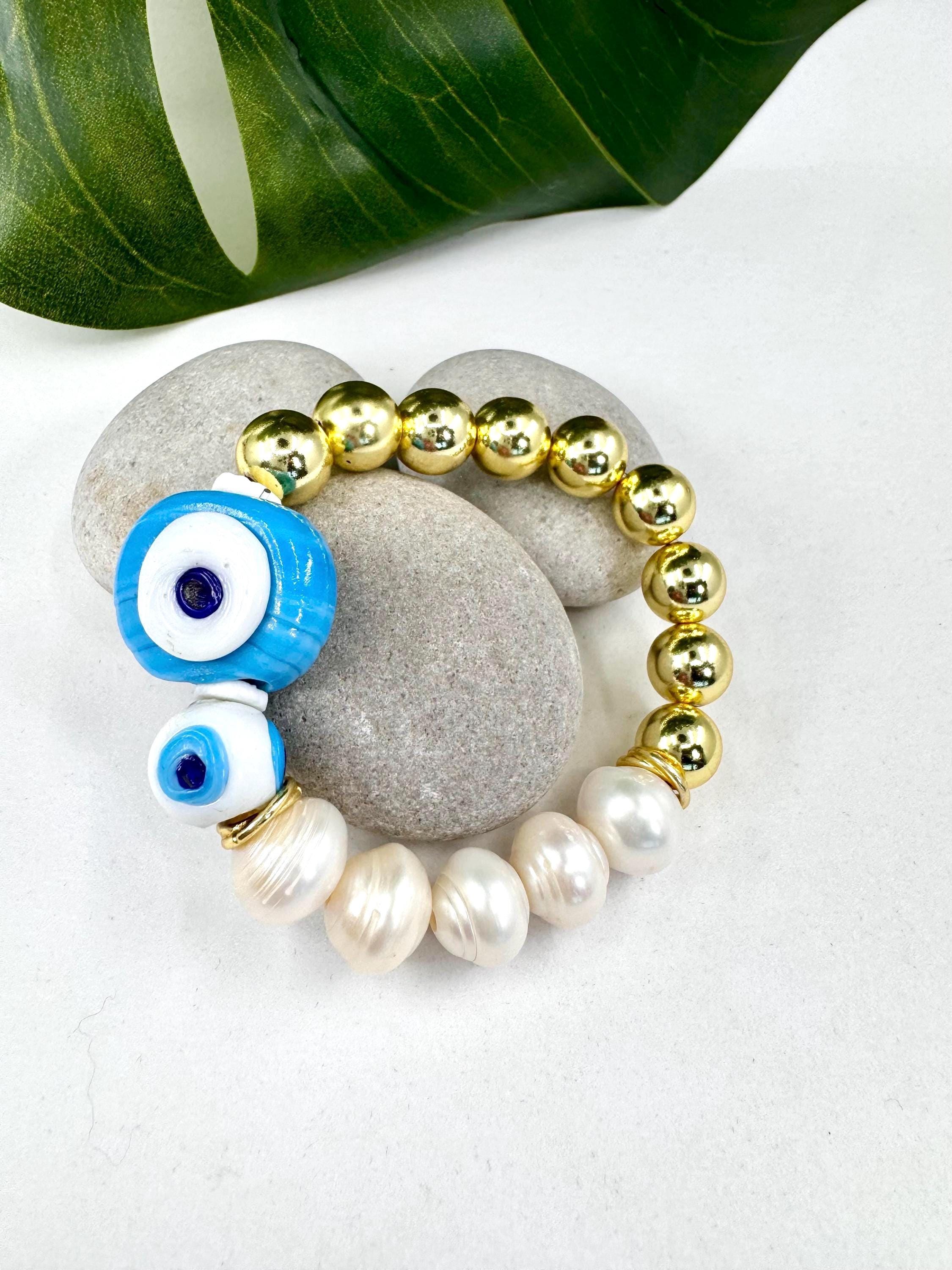 Blue & white evil eye bracelet with pearls and gold.