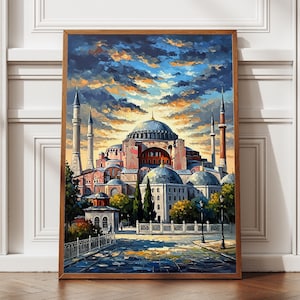 May include: A framed art print of the Hagia Sophia in Istanbul. The painting depicts the iconic building with its domes and minarets under a dramatic sky with shades of blue, orange, and yellow. The artwork is set in a wooden frame.