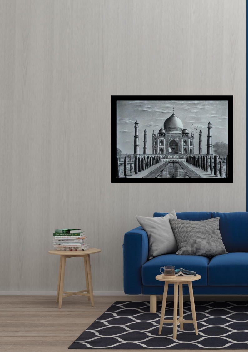 May include: A black and white pencil drawing of the Taj Mahal, a famous mausoleum in India. The drawing is framed and hanging on a wall in a living room setting.