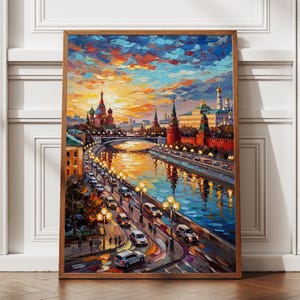 May include: A framed oil painting depicts a cityscape with a river, bridge, and buildings. The artwork features vibrant colors, including orange, blue, and yellow, with a focus on the architecture and reflections in the water. The painting is displayed on a wooden floor.