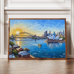May include: A framed oil painting depicts Sydney, Australia, with the Sydney Opera House and Harbour Bridge. The artwork features a vibrant blue harbor, a yellow sun, and a cityscape under a bright sky. The painting is in a brown wooden frame.