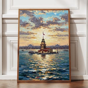 May include: Framed oil painting of the Maiden's Tower in Istanbul, Turkey, at sunset. The artwork features a detailed depiction of the tower, boats, and the surrounding water, with a warm color palette.