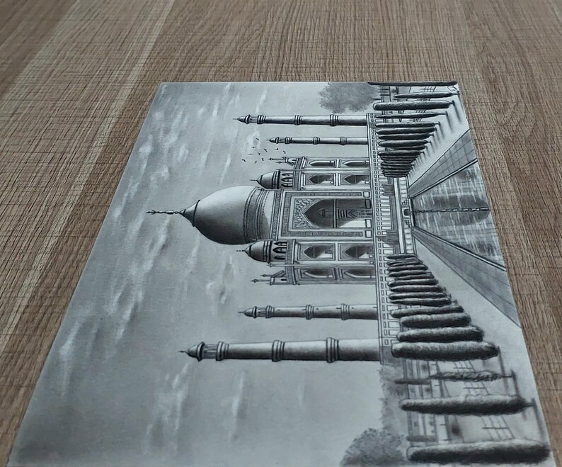 May include: A detailed pencil drawing of the Taj Mahal, a famous white marble mausoleum in Agra, India. The drawing depicts the intricate details of the building, including the minarets, domes, and arches. The drawing is done in shades of grey, creating a realistic and elegant depiction of the iconic landmark.
